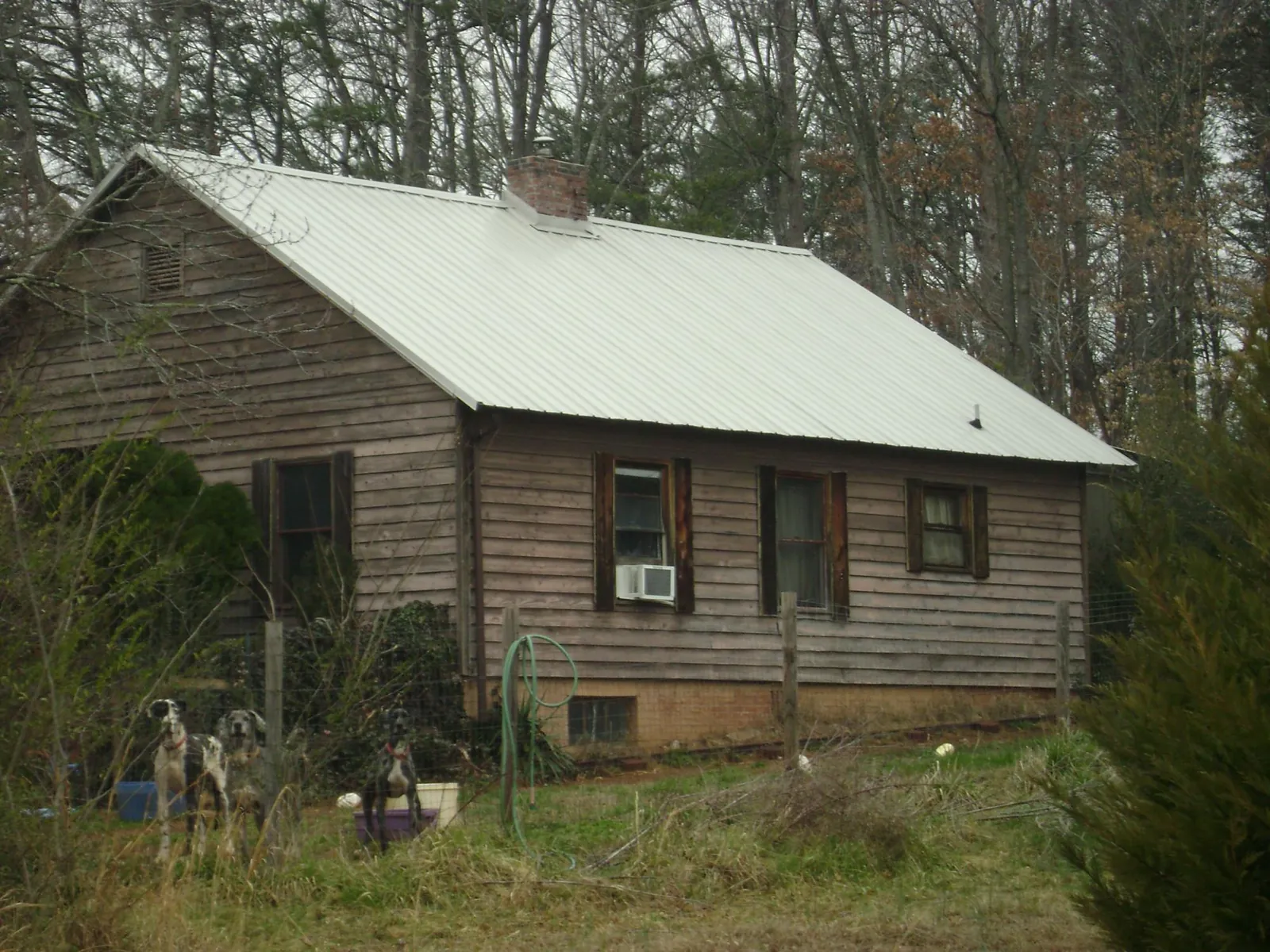White metal roof on an old wood sided farmhouse, from a Metal Roof Installation job in Paterson